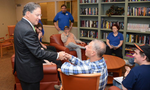 Assemblyman Bramnick shakes hands with day program participant Jack Russo